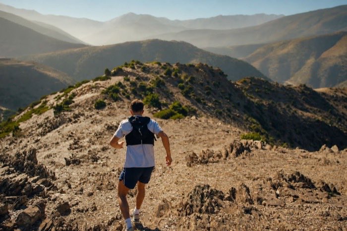 A runner climbing a rocky ridgeline high in the Atlas Mountains