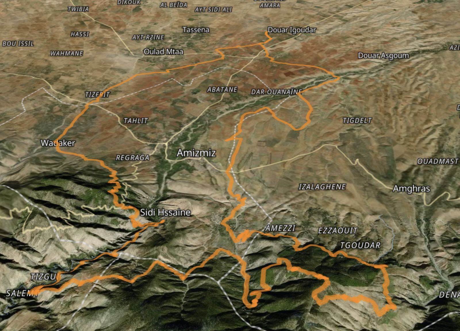 Bird's-eye satellite view of the 60km loop around Amizmiz in Morocco's High Atlas, the route traced in orange, with the Taj Atlas Hotel marked at the northern end.